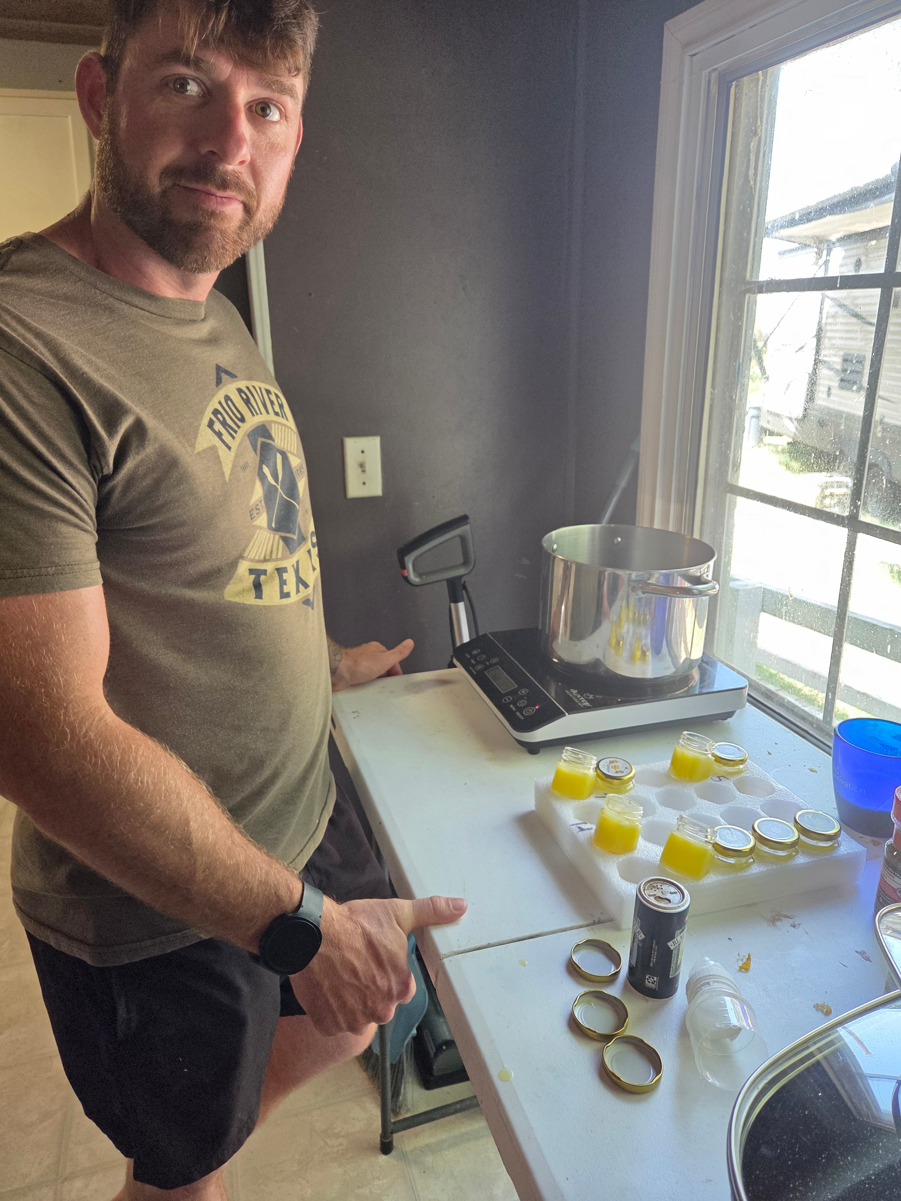 Dad making beeswax lip balms in the kitchen