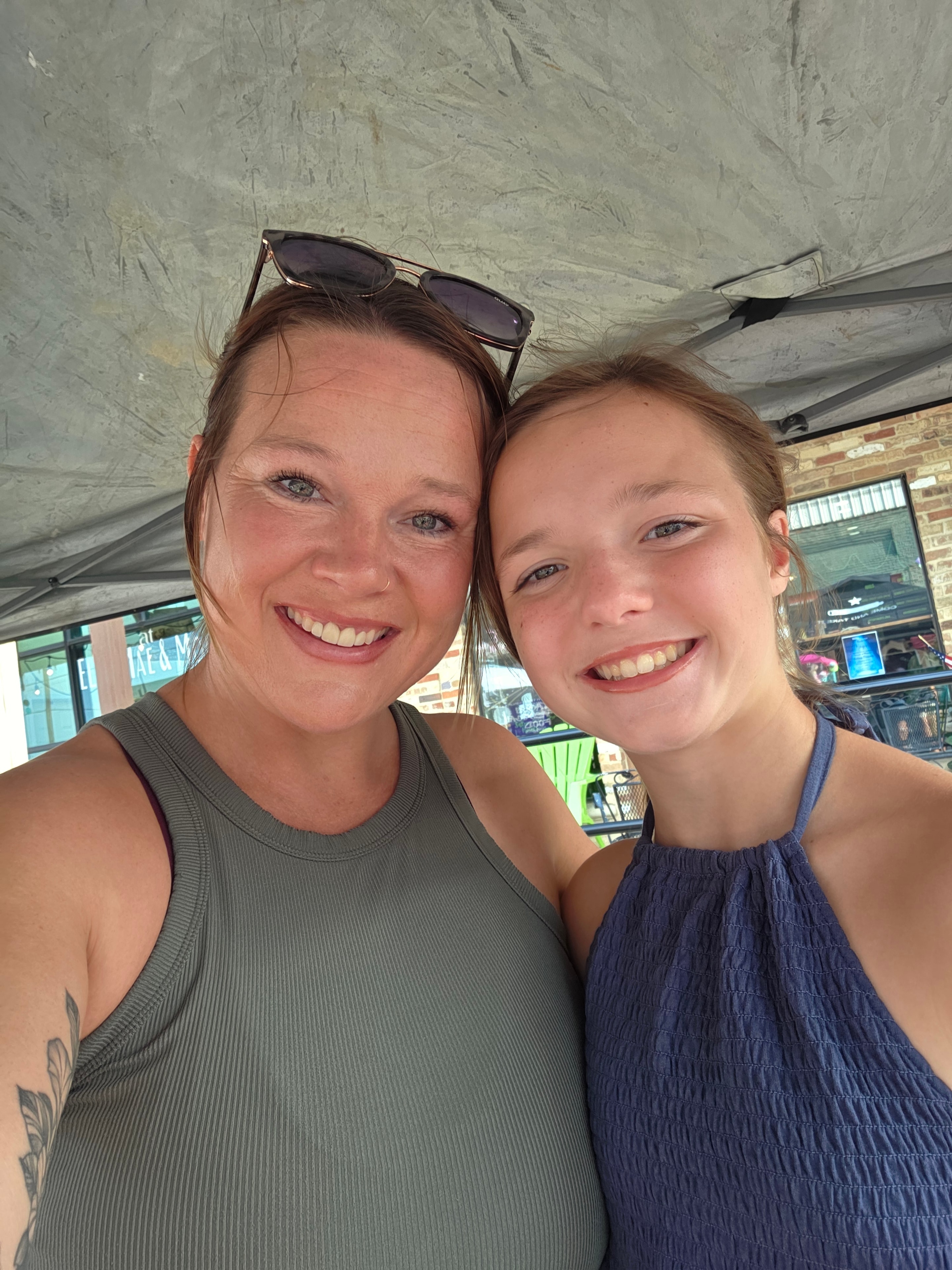 Mom and daughter smiling at the market
